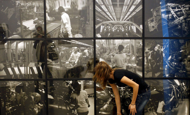 A young woman looks at some of the images included in the exhibition Universal Archive, which gathers approximately 2,000 vintage photographs and other documents dated between 1851 and 2008 by about 250 artists, such as Lewis Hine, Atget, El Lissitzky, Dorothea Lange, Walker Evans, Centelles, Martha Rosler and William Klein. EFE / XAVIER BERTRAL.