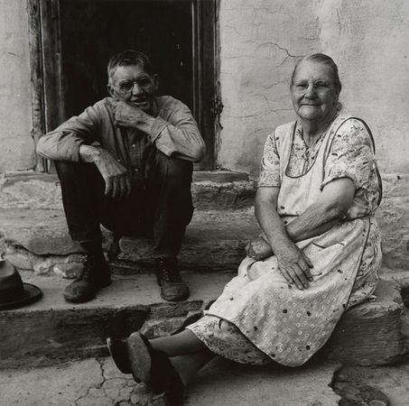 Dorothea Lange (1895-1965), Couple Seated on Porch, Gunlock, Utah, 1953, Gelatin silver print, Brigham Young University Museum of Art, purchased with funds donated by Jack and Mary Lois Wheatley. ©Dorothea Lange Collection, Oakland Museum of California, City of Oakland. Gift of Paul S. Taylor.