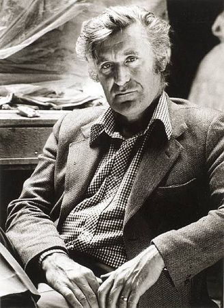 HUGHES, TED (1930-1998, poet, O.M.). 
PORTRAIT BY NOEL CHANAN (b. 1939), vintage photograph, silver print, showing Ted Hughes, three-quarter length, looking into the camera, seated in his great friend Leonard Baskin